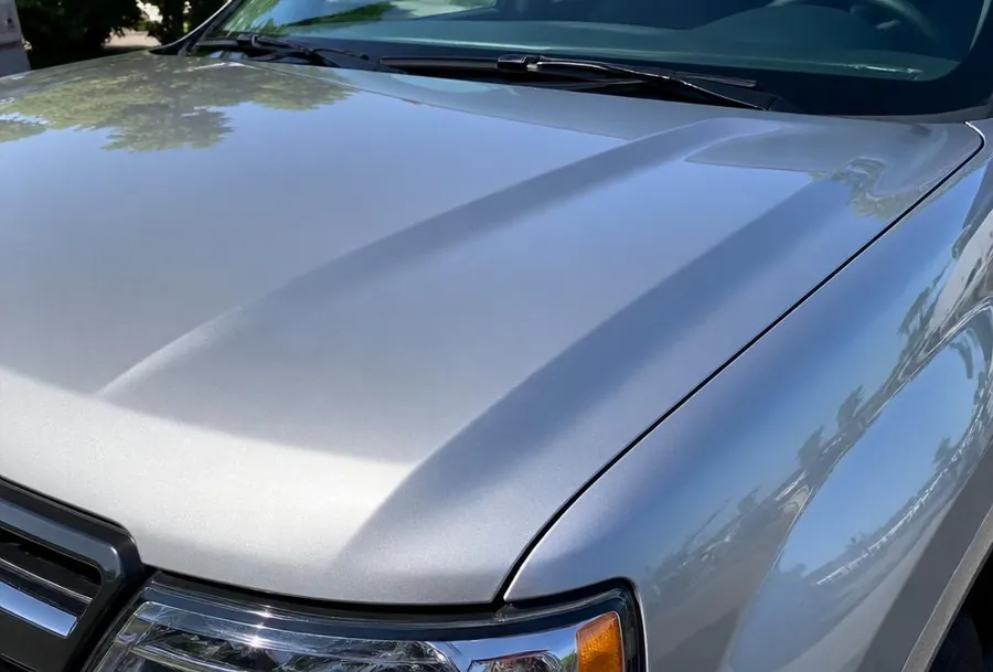 Hail-damaged Hood Restoration after — Hood beat up by hail — brought back to a factory-smooth finish with paintless dent repair.